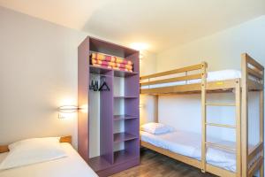 a bunk bed room with two bunk beds and a ladder at VVF Les 7 Laux Massif de Belledonne in Prapoutel +49 photos
