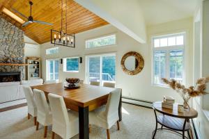 a dining room with a wooden table and white chairs at The Mountain House Windham Retreat with Hot Tub! in Windham