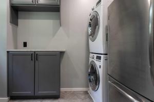 a laundry room with a washer and dryer at The Mountain House Windham Retreat with Hot Tub! in Windham