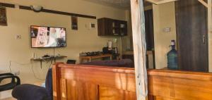 sala de estar con sofá y TV en la pared en Aim Furnished Homes in Mtwapa near Beach, en Mtwapa