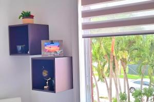 a room with a window with a purple cabinet at Chic Ocean Miami 88 in Miami