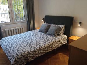 a bedroom with a bed with two pillows on it at Apartment LOZENEC in Sofia