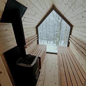 an inside view of a wooden cabin with a window at Schody do wody Domek z linią brzegową Kaszuby sauna goraca balia 