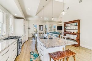 a kitchen with a large island with a counter top at Sunset Cove at Palmilla Beach in Port Aransas