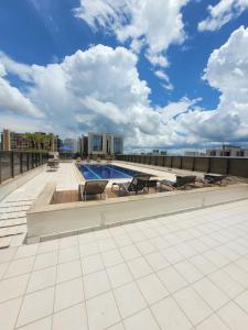 a swimming pool on the roof of a building at Comfort Suites By Rei dos Flats in Brasília