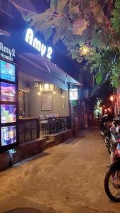 a restaurant with a bar with motorcycles parked in front of it at Amy 2 Hostel Hue in Hue