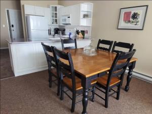 a dining room table with chairs and a kitchen at Mountain View Vacation Villa Main Floor Unit, No Stairs in Fairmont Hot Springs