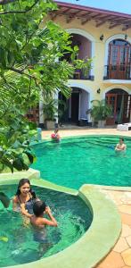 a group of people swimming in a swimming pool at Hotel La Polvora in Granada