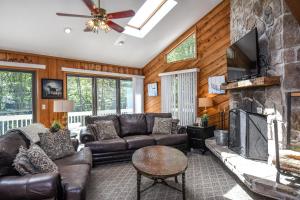 a living room with leather furniture and a stone fireplace at Cedar Ridge in Oakland