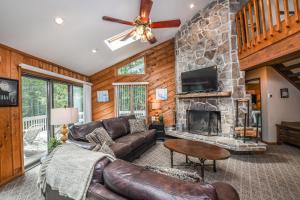 a living room with a couch and a stone fireplace at Cedar Ridge in Oakland