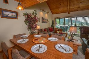 a living room with a wooden table with plates on it at Sunplace 07 in McHenry