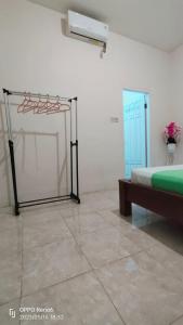 a room with a bed and a glass door at Pineapple Guest House in Gili Air