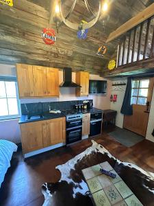 a kitchen with wooden cabinets and a stove at Lake View Lodges in Long Melford