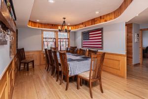 a dining room with a table and a flag on the wall at Sunkissed Lodge in McHenry +39 photos