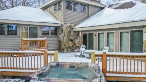 a house with a hot tub in the snow at Johnny Appleseed in Oakland
