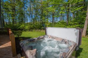 a jacuzzi tub in a yard with trees at Johnny Appleseed in Oakland