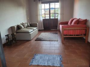 a living room with two couches and a rug at Dpto Céntrico con Balcón Dpto 1 in Puerto Iguazú