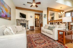 a living room with a white couch and a fireplace at Ski Harbor 19 in McHenry