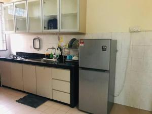 a kitchen with a refrigerator and a sink at Home in Bayan Lepas4R3B Dnaz Homestay@Bayan Baru in Bayan Lepas