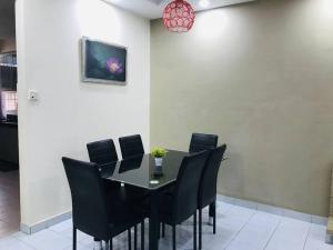 a dining room with a black table and black chairs at Home in Bayan Lepas4R3B Dnaz Homestay@Bayan Baru in Bayan Lepas