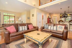 a living room with two brown leather couches and a table at Sunset Cove in Swanton +40 photos