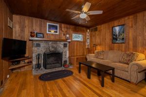 a living room with a couch and a fireplace at Ski Shore in Swanton