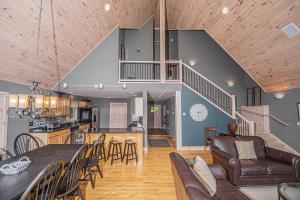 a large kitchen and living room with a table and chairs at Play-A-Way Chalet in McHenry