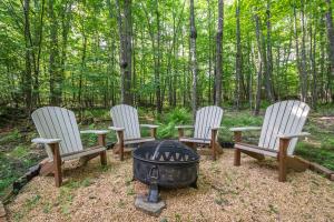 a group of three chairs around a fire pit at Play-A-Way Chalet in McHenry