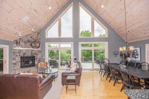 a living room with a table and a fireplace at Play-A-Way Chalet in McHenry