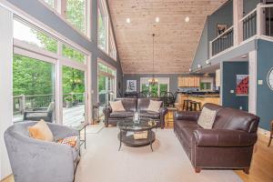 a living room with couches and a table at Play-A-Way Chalet in McHenry +47 photos