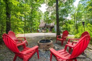 a group of red chairs sitting around a fire pit at Sparkys Lodge in McHenry