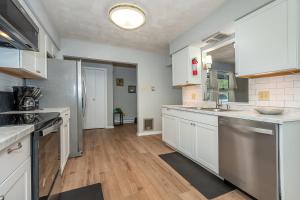 a kitchen with white cabinets and stainless steel appliances at Waltzing Matilda in Swanton