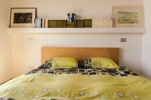 a bed with two yellow pillows in a bedroom at Borgo San Rocco Piemonte in Castino