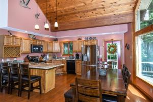 a kitchen with wooden cabinets and a wooden ceiling at Slip Away Chalet in McHenry