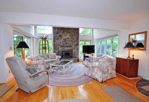 a living room with two chairs and a fireplace at Sunrise in Oakland