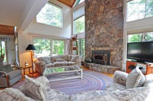 a living room with couches and a stone fireplace at Sunrise in Oakland