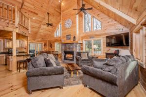 a living room with two couches and a fireplace at Wander Inn in McHenry