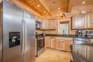 a kitchen with wooden cabinets and a stainless steel refrigerator at Wander Inn in McHenry