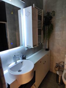 Un baño con un lavabo blanco y un espejo. en Old Town Italian Courtyard, en Tiflis 32 fotos más