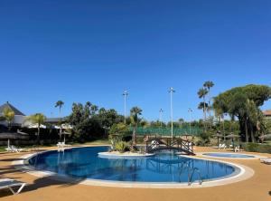 a large swimming pool in a resort at Ático Dunas Islantilla in Islantilla