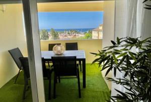 a dining room with a table and a view of the ocean at Ático Dunas Islantilla in Islantilla