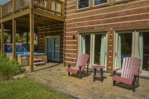 two chairs and a ping pong table on a patio at Mountain Top Lodge in McHenry