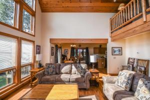 a living room with two couches and a staircase at Mountain Top Lodge in McHenry