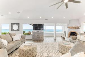 a living room with a couch and a fireplace at Island Time -- Oceanfront Bliss in Saint Augustine