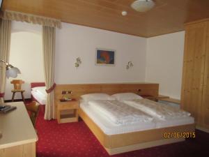 מיטה או מיטות בחדר ב-Garni La Majon