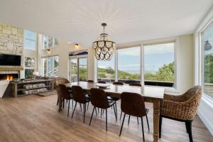 a dining room with a table and chairs and a fireplace at Crescent Lookout Oceanfront with panoramic views in St. Augustine