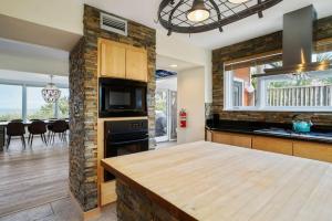 a kitchen with a stone wall and a counter top at Crescent Lookout Oceanfront with panoramic views in St. Augustine