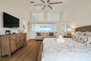 a bedroom with a large bed and a television at Crescent Lookout Oceanfront with panoramic views in St. Augustine