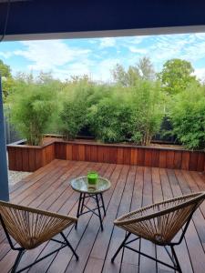 a patio with a table and chairs on a deck at La Suite in Brie