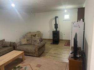 a living room with a couch and a tv at Villa Giti in Boge